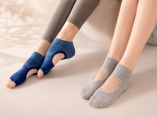 Open toe and full toe yoga grip socks on a soft studio background
